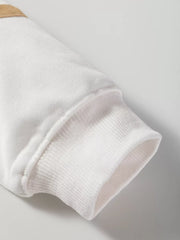 White knit loungewear top sleeve with ribbed cuff detail and tan accent.