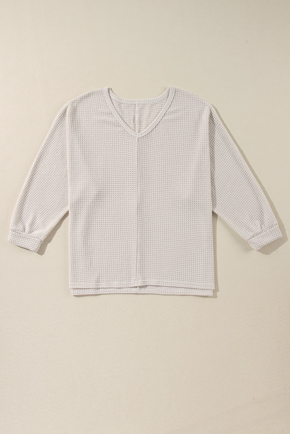 Beige waffle knit v-neck long sleeve top with slit hem detail
