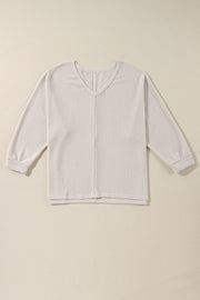 Beige waffle knit v-neck long sleeve top with slit hem detail