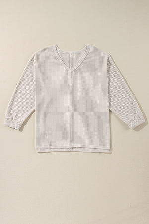 Beige waffle knit v-neck long sleeve top with slit hem detail