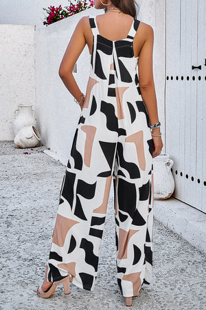 Abstract print wide leg jumpsuit with black, white, and tan shapes.