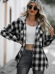 Oversized black and white plaid hooded shirt jacket with button front and chest pockets.