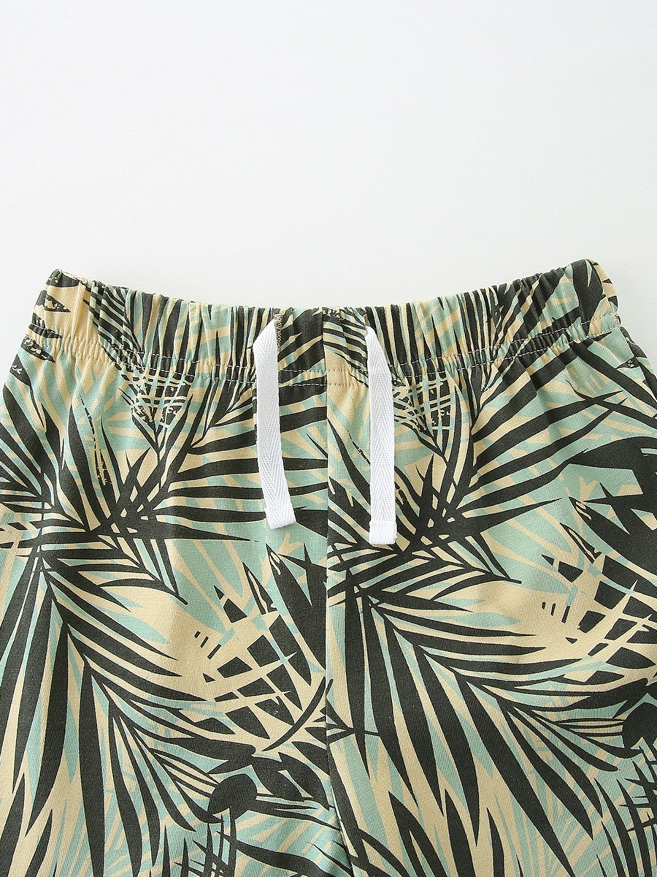 Baby cotton shorts with tropical leaf print and white drawstring waist