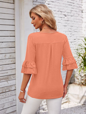 Watermelon pink blouse with ruffled sleeves and square neckline.
