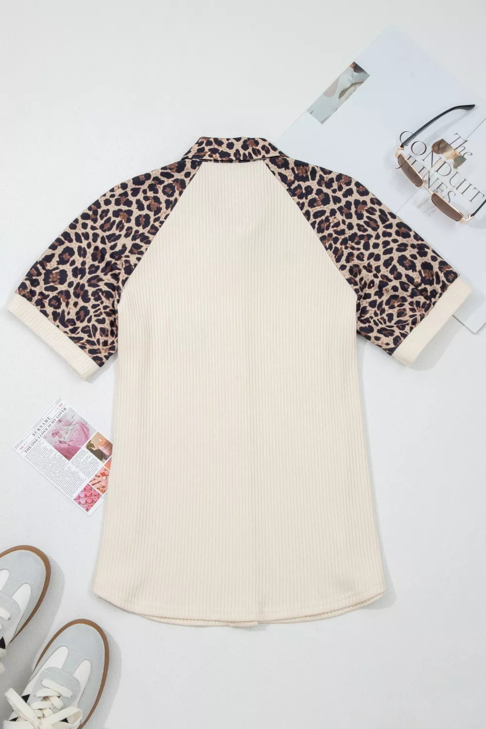 Ribbed cream shirt with leopard print raglan sleeves and collar.
