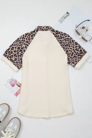Ribbed cream shirt with leopard print raglan sleeves and collar.