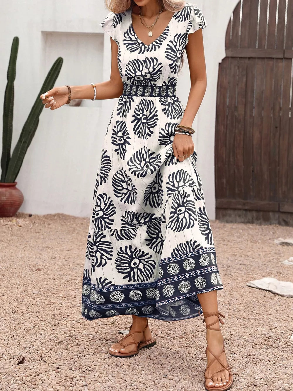 Botanical print V-neck maxi dress with cap sleeves and a smocked waist.