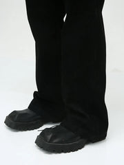 Dark bootcut denim trousers with a classic fit and a subtle flare.