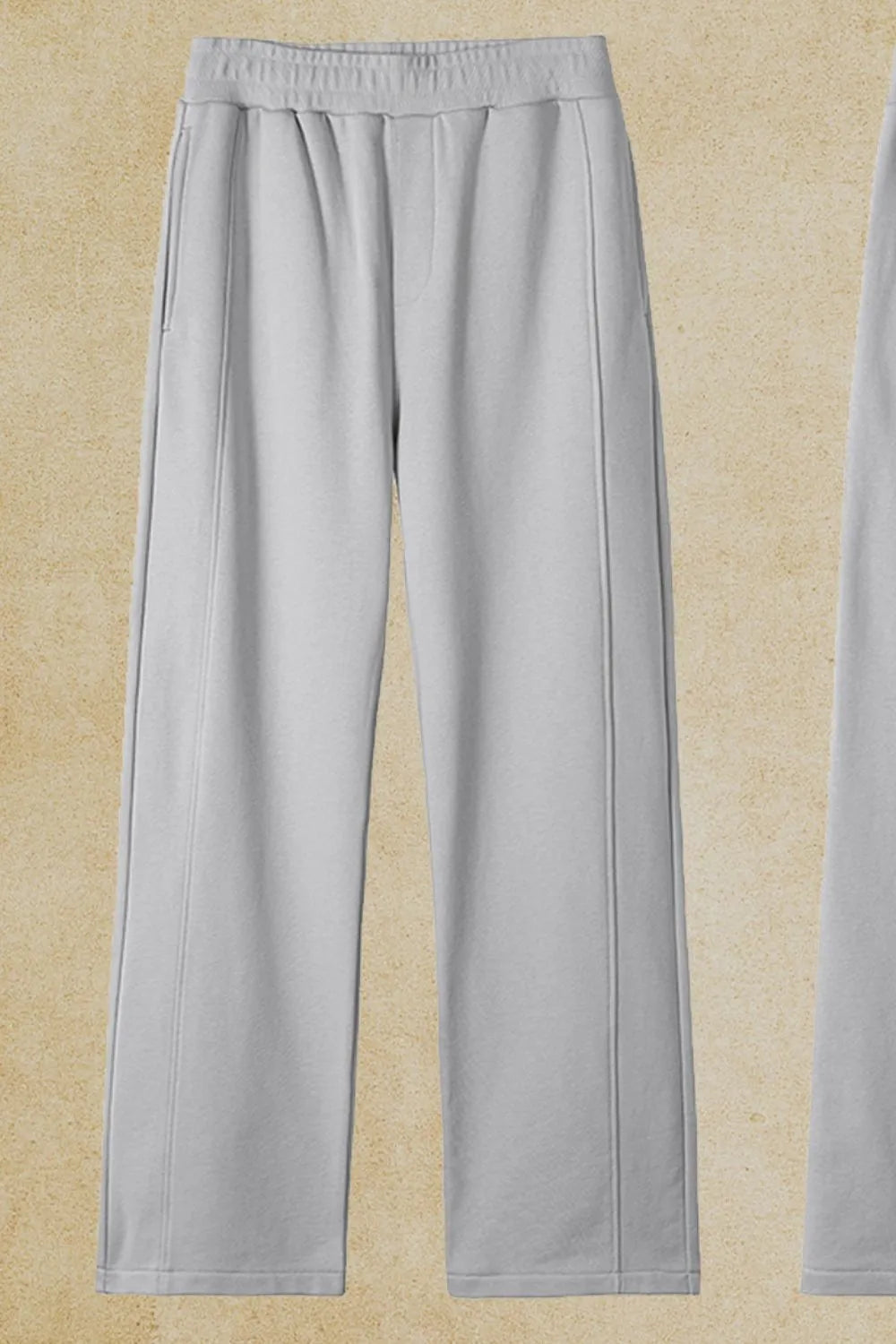 Gray seamed lounge trousers with elastic waist and pockets.