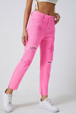 Pink denim jeans with star patches and distressed rips, cropped frayed hem