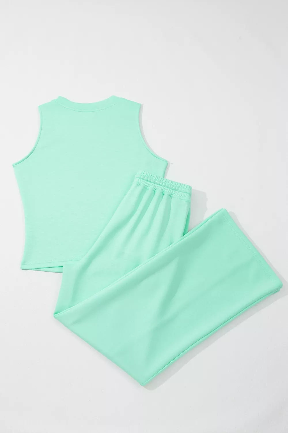 Sleek mint green drawstring lounge set with sleeveless top and wide-leg pants.