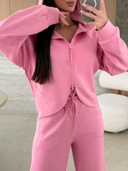 Dusty pink relaxed fit zip-up hoodie and drawstring pants set with a cropped hem detail.
