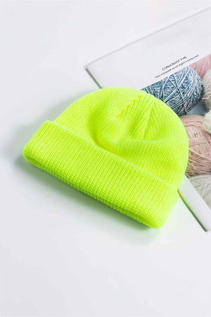 Ribbed knit beanie with a turn-up cuff in bright yellow acrylic.