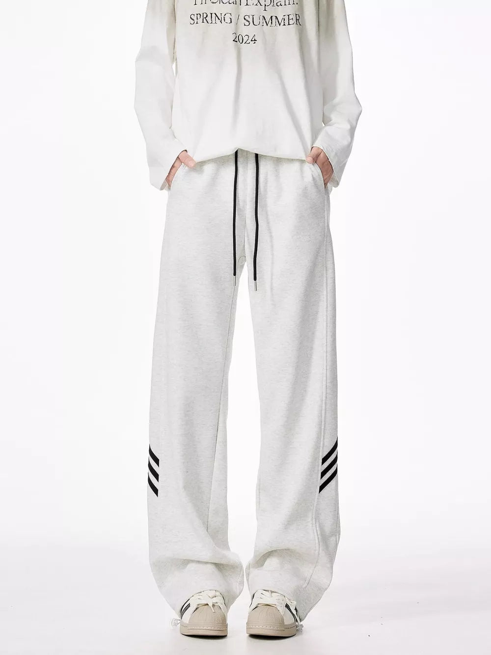 Light gray relaxed fit sweatpants with drawstring and black side stripes