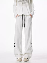Light gray relaxed fit sweatpants with drawstring and black side stripes