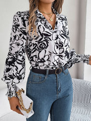 White floral print blouse with shirred cuffs and button front, styled with jeans.