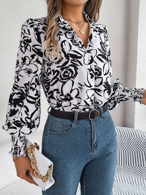 White floral print blouse with shirred cuffs and button front, styled with jeans.