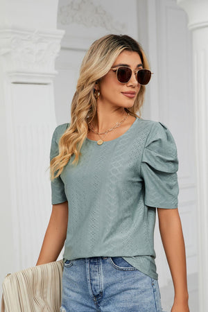 Teal perforated sleeve volume blouse with round neckline and puff sleeves.