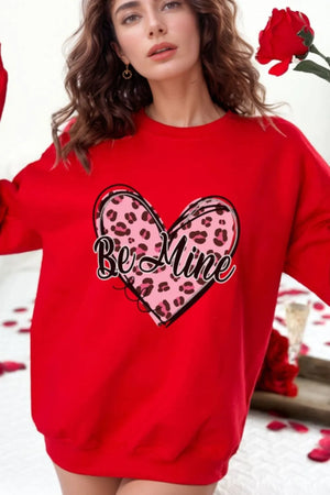 Red crewneck sweatshirt with a pink leopard print heart graphic that says "Be Mine".