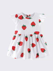 White cotton baby dress with allover red strawberry print and ruffle sleeves.