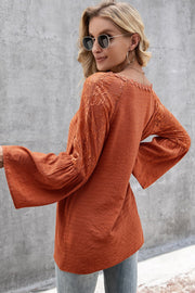 Orange-red blouse with lace sleeves and scallop trim, bell sleeves, relaxed fit.