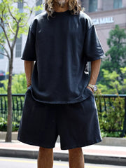 Men's dark gray relaxed fit two-piece set with drawstring shorts and crew neck tee.