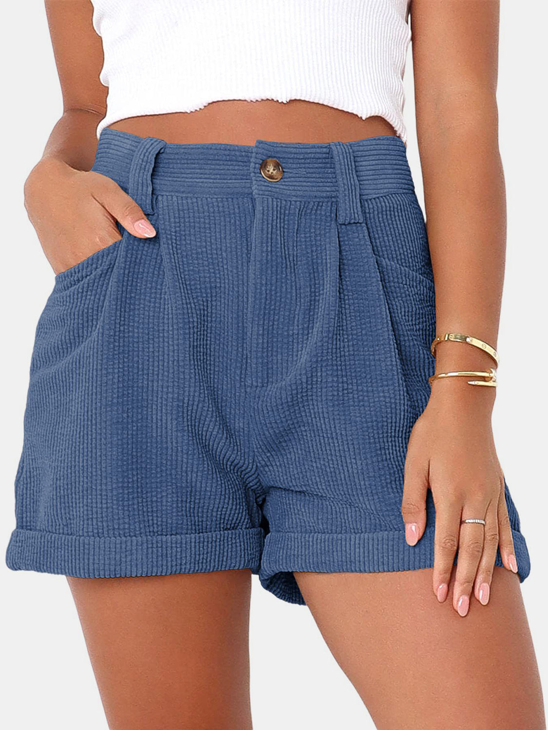 Dusty blue corduroy high-waist shorts with pleats and cuffed hems.