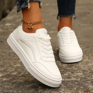 White lace-up casual sneakers with iridescent stripe detail and gold heart anklet.