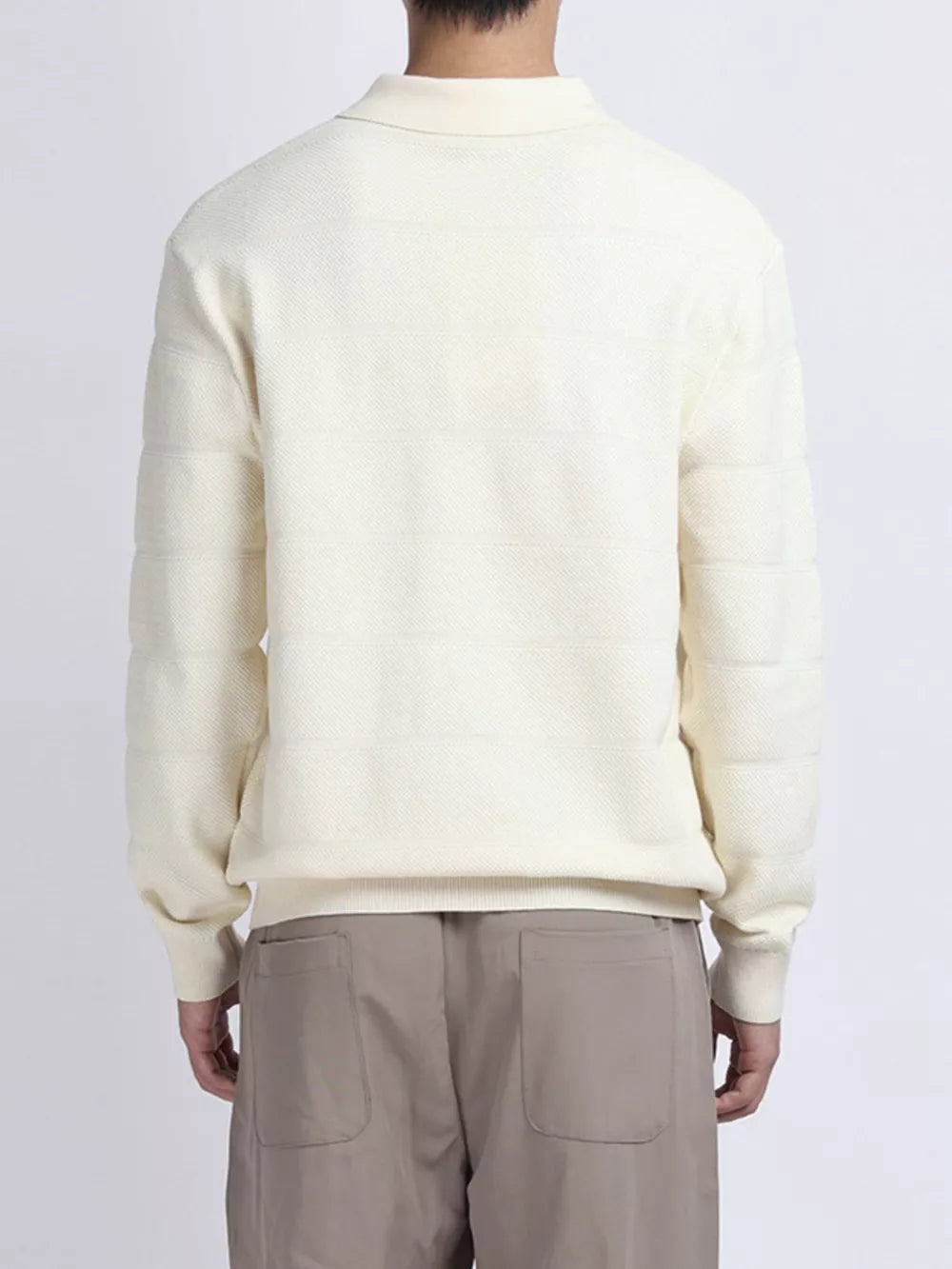 Men's Apricot knit polo top with textured stripes and button accents.