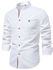 White linen shirt with mandarin collar, buttoned front, and blue embroidered detail.