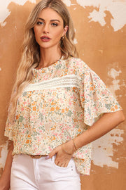 Floral ruffle trim blouse with keyhole neckline and lace detail