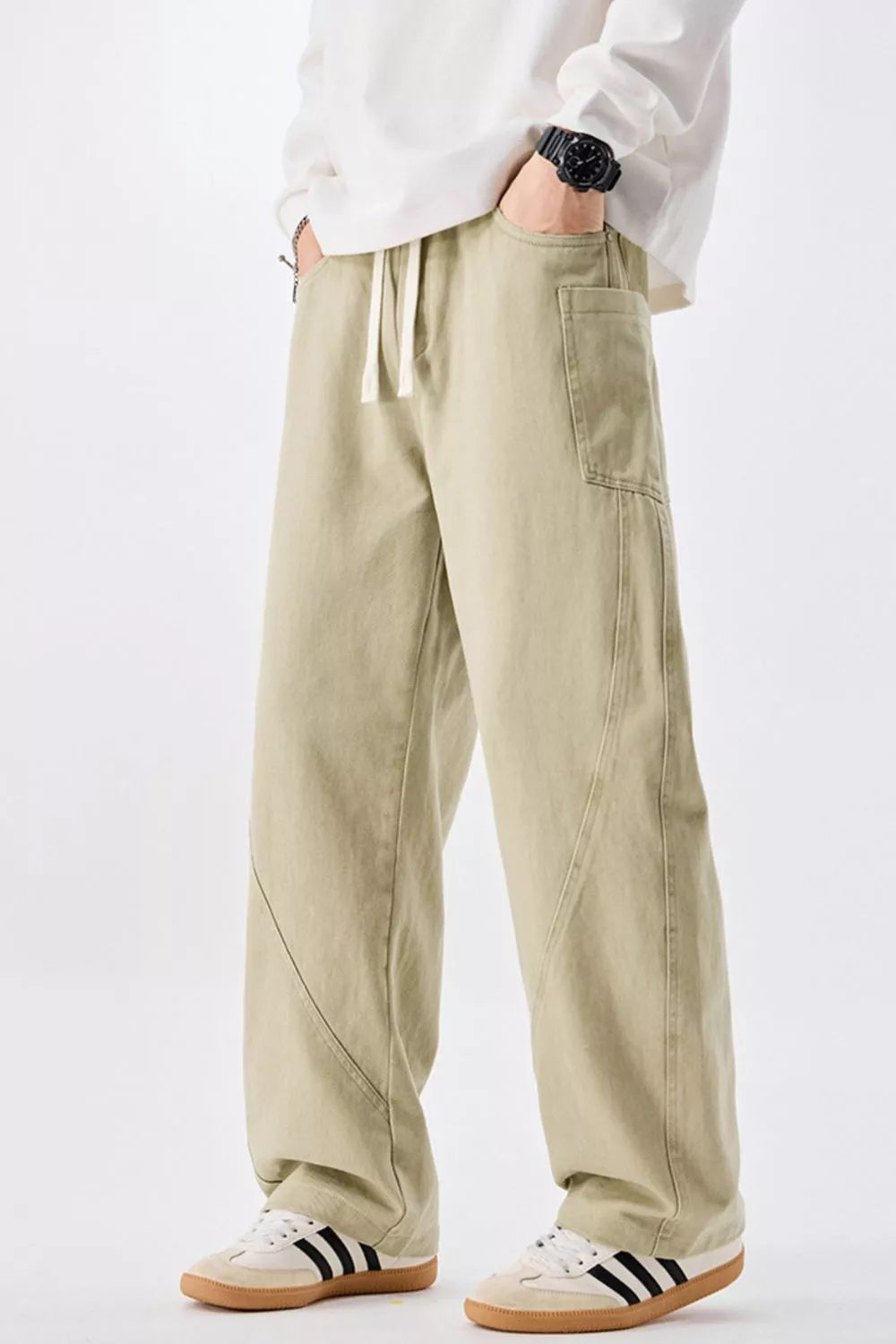 Relaxed fit men's sage cotton jeans with drawstring waist and utility pockets.