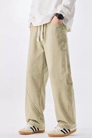 Relaxed fit men's sage cotton jeans with drawstring waist and utility pockets.