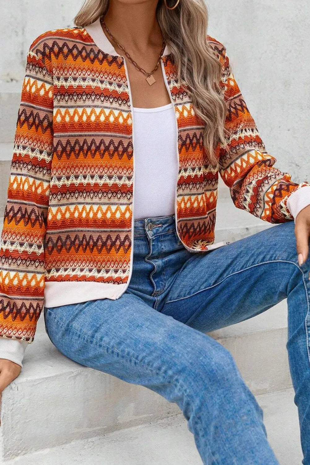 Geometric knit bomber jacket in orange with a full zip and ribbed cuffs and hem.
