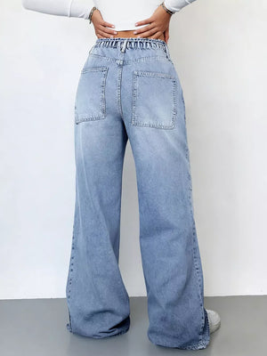 Light wash denim wide-leg cargo jeans with elastic waistband and large back pockets.