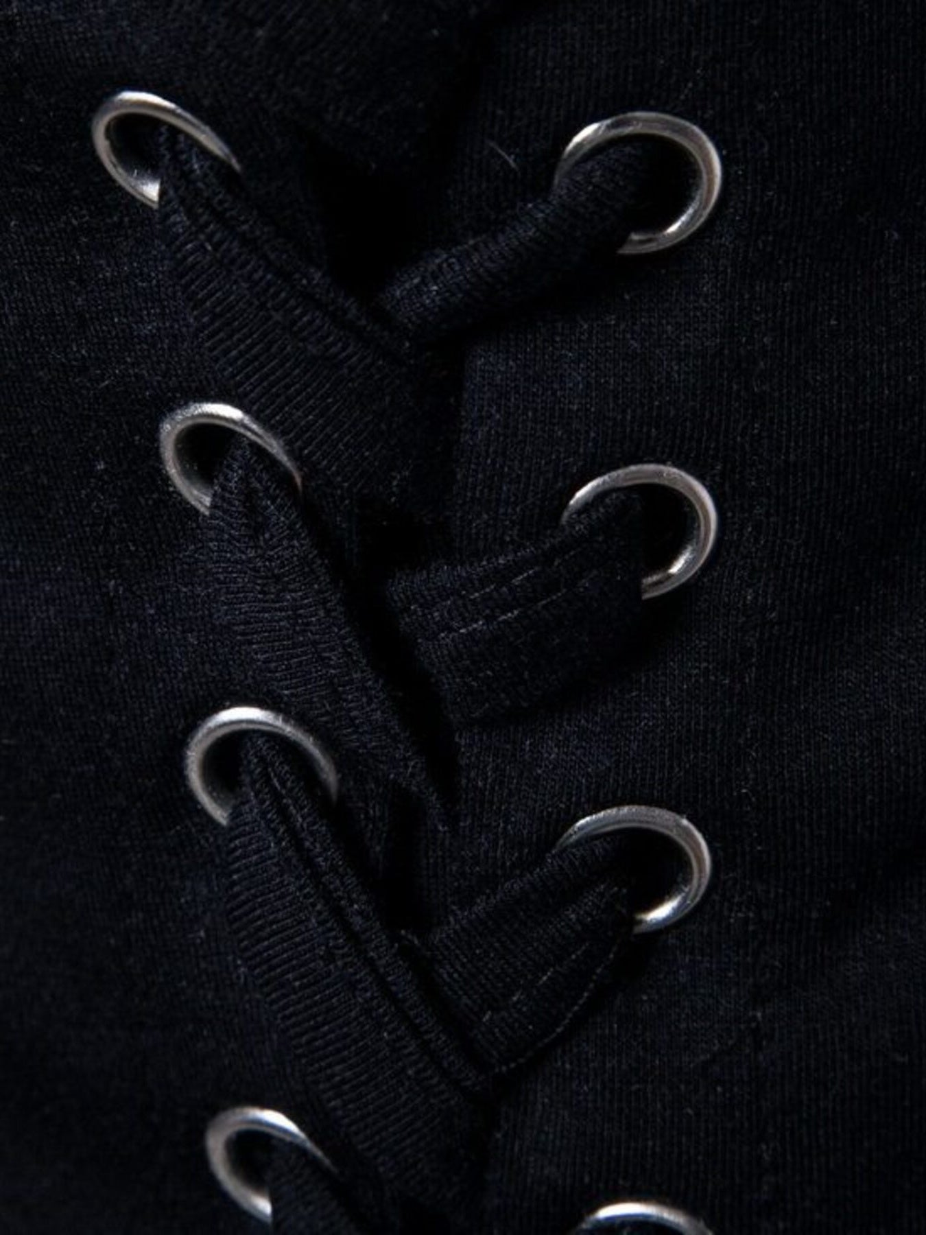 Black cotton t-shirt with silver grommets and lace-up detail.
