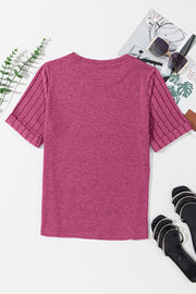 Hot pink t-shirt with ribbed short sleeves and rolled cuffs.