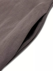Elegant midi dress in coffee brown with a visible side pocket detail.