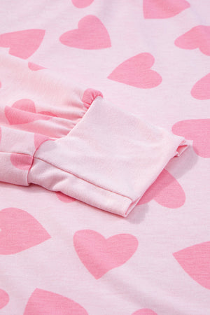 Blush pink lounge set with allover heart print and cuffed sleeves.