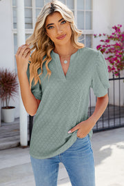 Light Green eyelet V-neck blouse with puff sleeves and diamond pattern.