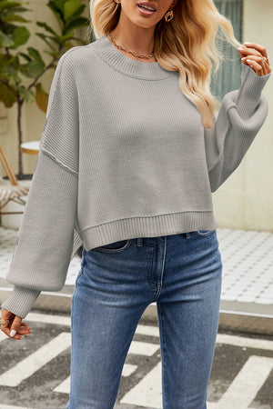 Light gray boxy ribbed knit sweater with crewneck and balloon sleeves.