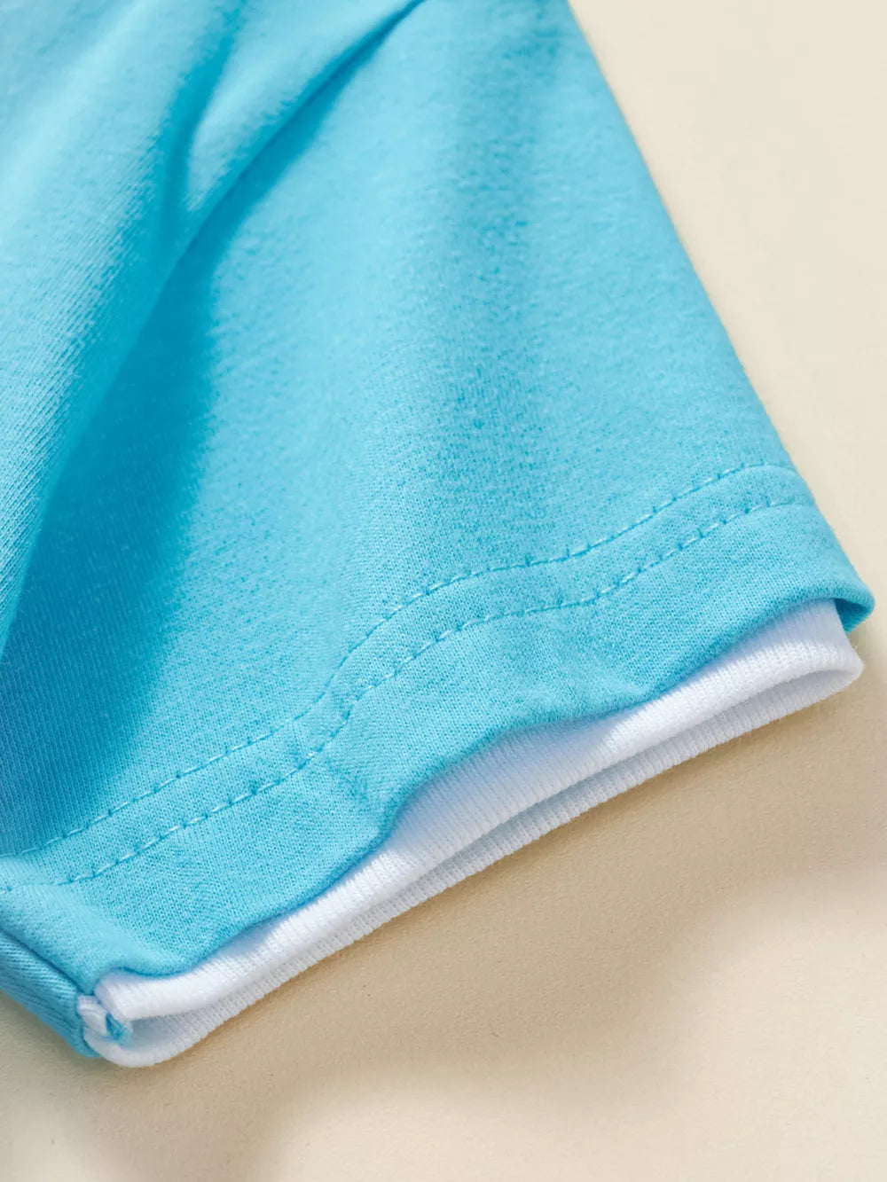 Baby blue cotton tee with white layered hem detail