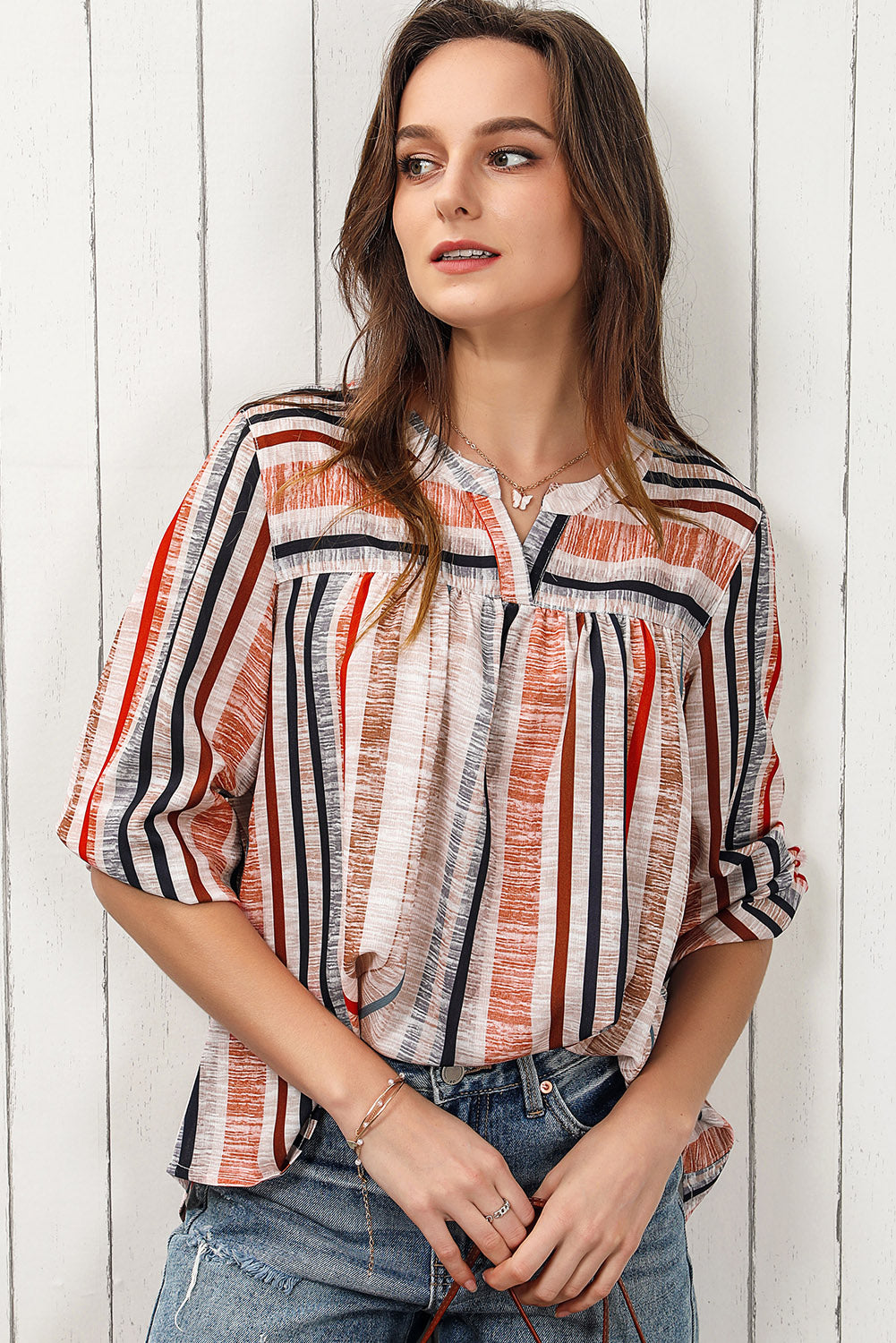 Vertical stripe gathered yoke blouse with V-neck and 3/4 sleeves.