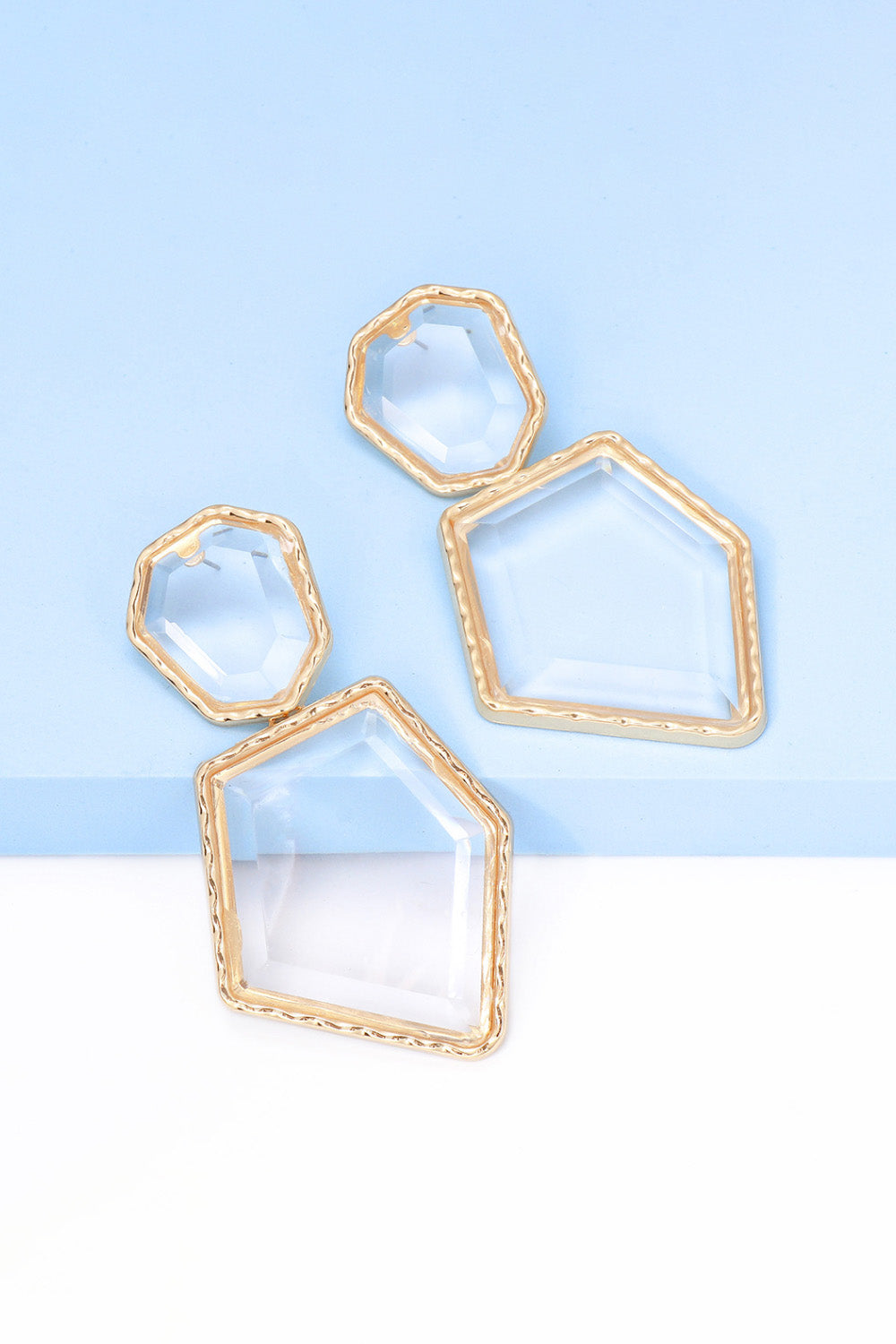 Clear resin facet drop earrings with gold trim, various geometric shapes.
