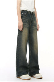 Whiskered denim straight leg jeans in a dark wash with a vintage fade.