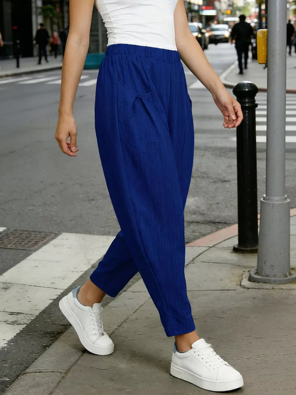 Royal blue harem pants with pockets and elastic waist, styled with white sneakers.