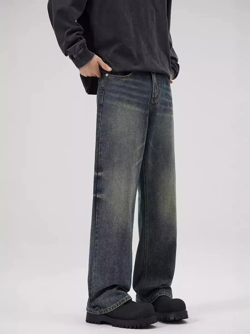 Men's relaxed fit jeans in faded blue denim with a vintage wash.