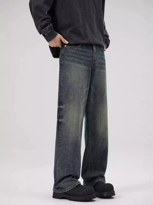 Men's relaxed fit jeans in faded blue denim with a vintage wash.