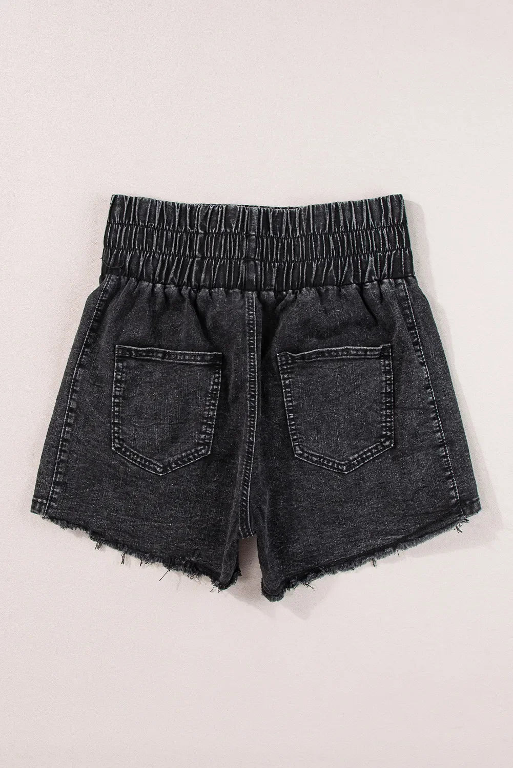 Black washed denim shorts with elastic waist and frayed hem