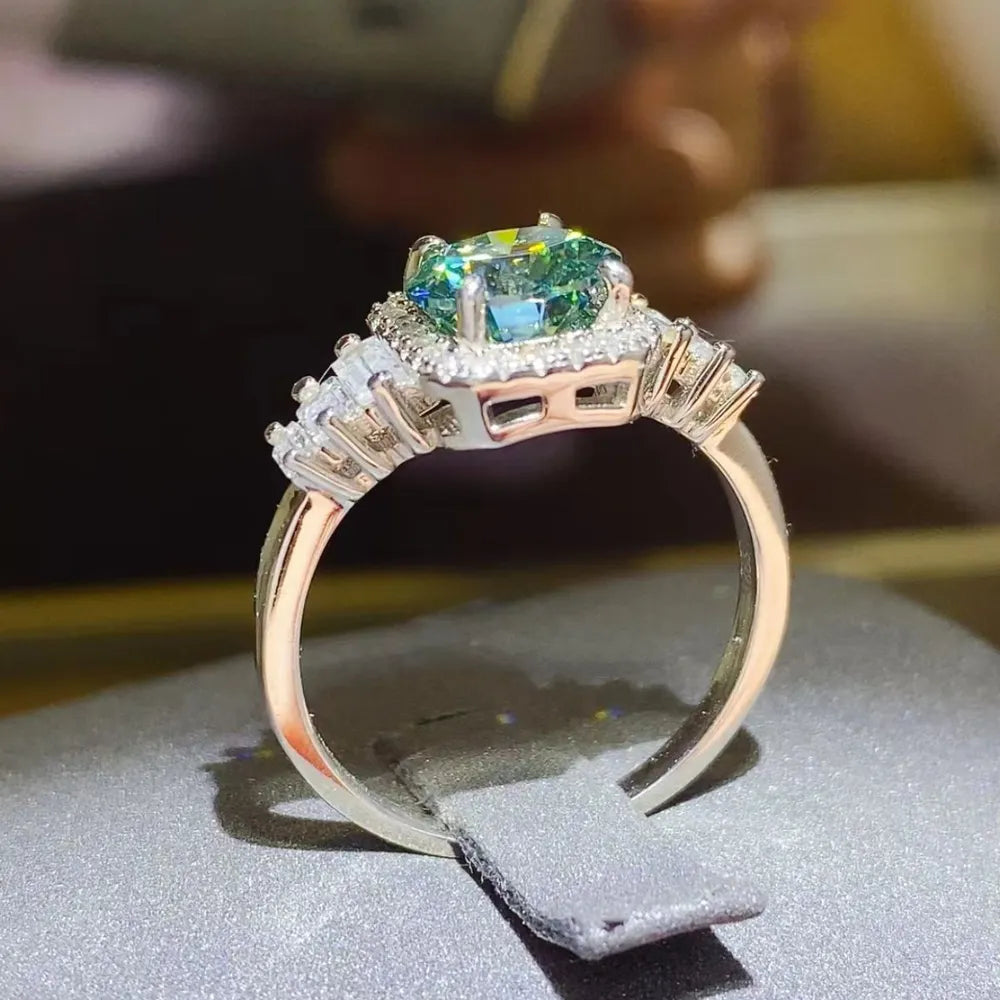 Emerald halo ring with baguette side stones in silver.